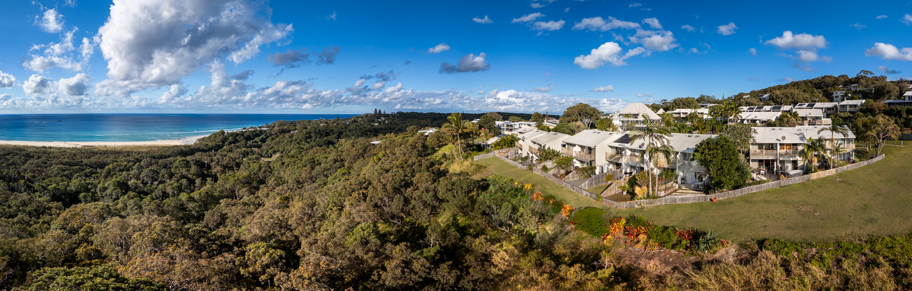 Panorama across the headland at Point Lookout, with the beach curving away to the north