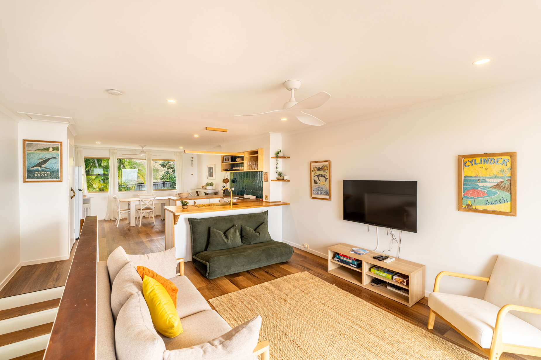 Open plan living room and kitchen inside a Deluxe Ocean villa at Pandanus Palms Resort