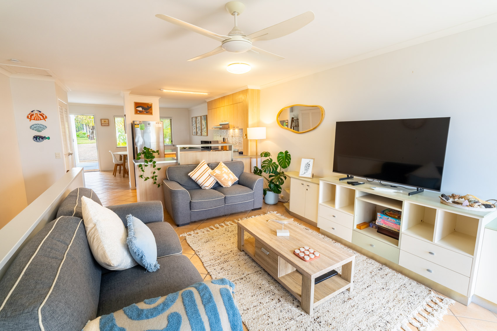 Open plan living room and kitchen inside a Deluxe Ocean villa at Pandanus Palms Resort