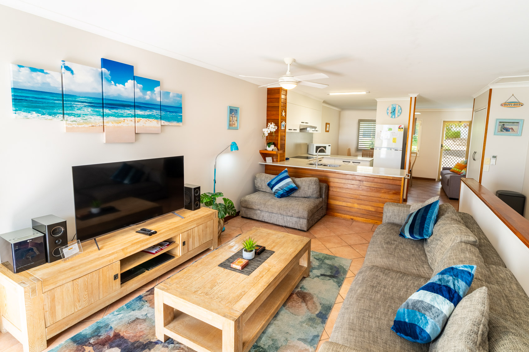 Open plan living room and kitchen inside a Deluxe Ocean villa at Pandanus Palms Resort