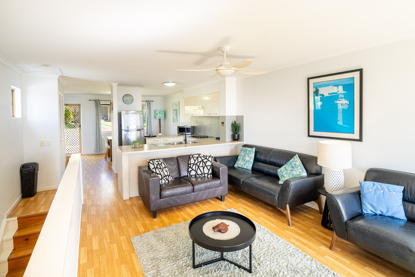 Open plan living room and kitchen inside a Standard Ocean 3 bedroom villa at Pandanus Palms Resort