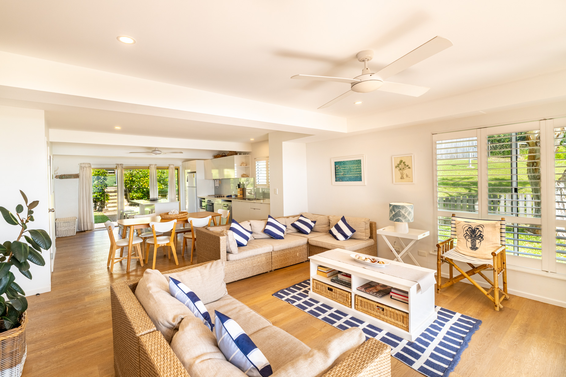 Open plan living room and kitchen inside a Prestige Headland Ocean 3 bedroom villa at Pandanus Palms Resort