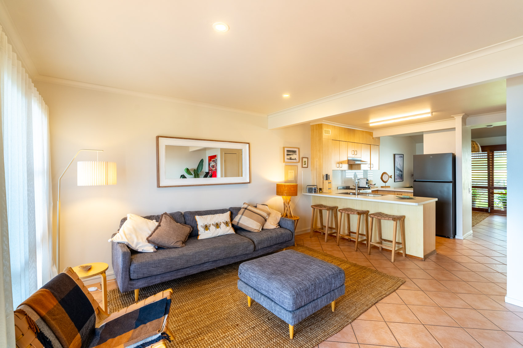 Open plan living room and kitchen inside a Prestige Headland Ocean villa at Pandanus Palms Resort