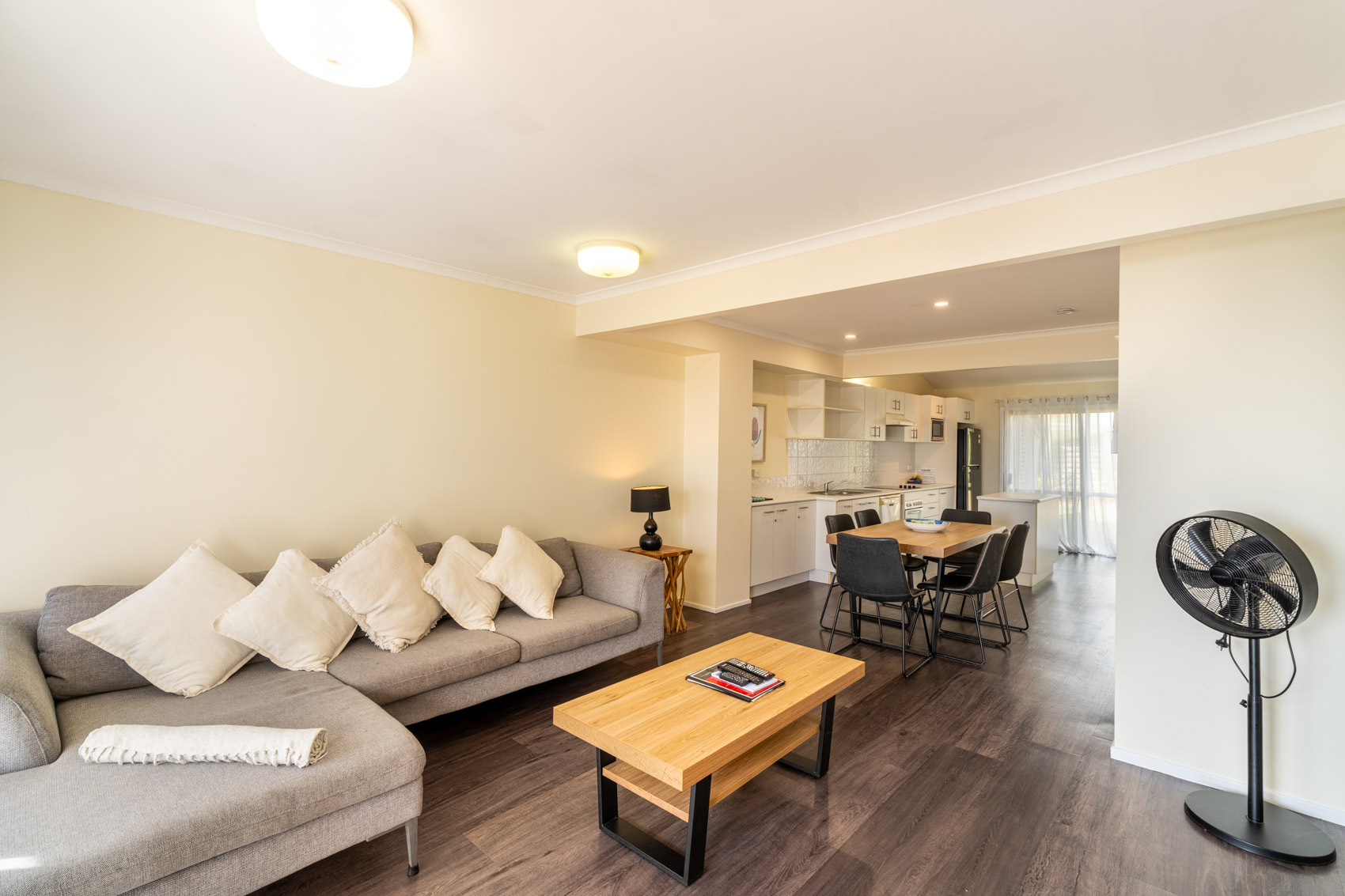 Open plan living room and kitchen inside a Premium Headland Ocean villa at Pandanus Palms Resort