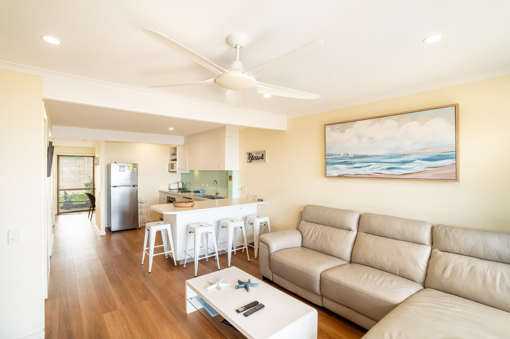 Open plan living room and kitchen inside a Premium Headland Ocean villa at Pandanus Palms Resort