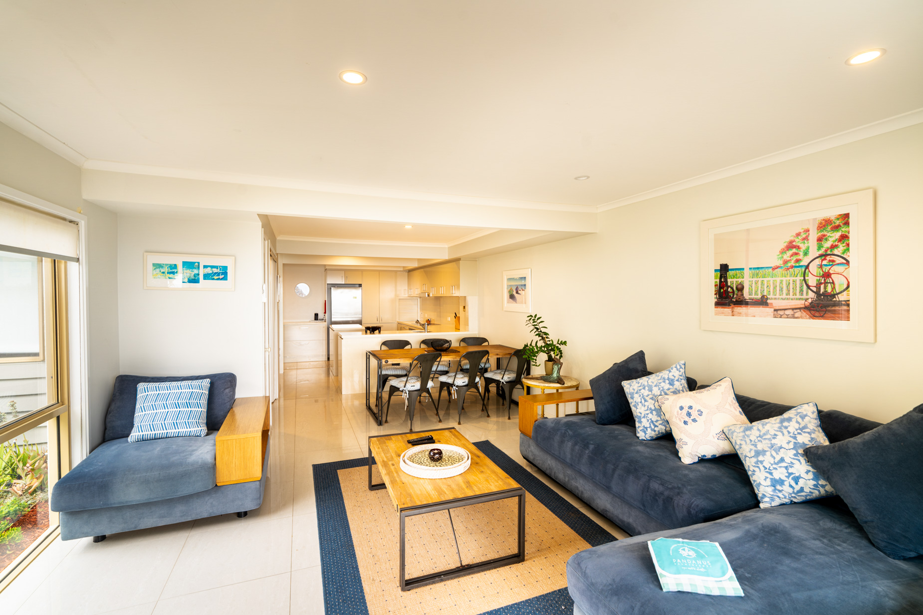 Open plan living room and kitchen inside a Prestige Headland Ocean 3 bedroom villa at Pandanus Palms Resort