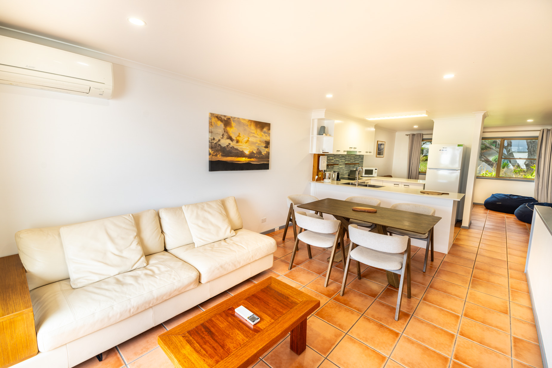 Open plan living room and kitchen inside a Deluxe Ocean villa at Pandanus Palms Resort