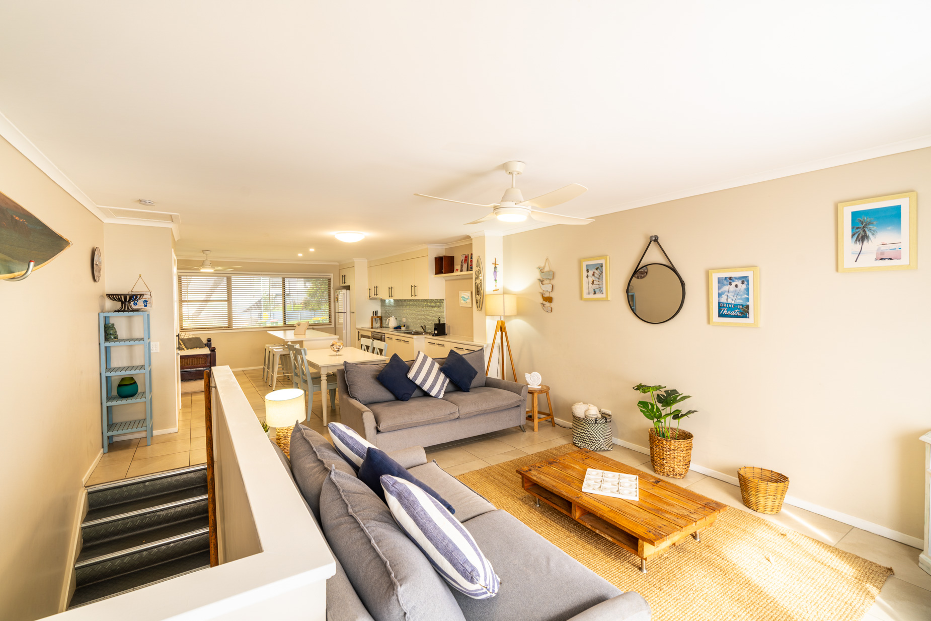 Open plan living room and kitchen inside a Deluxe Ocean villa at Pandanus Palms Resort